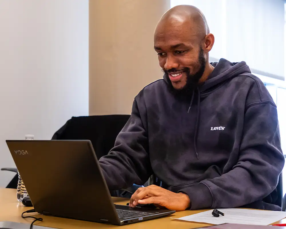 male student working at a laptop