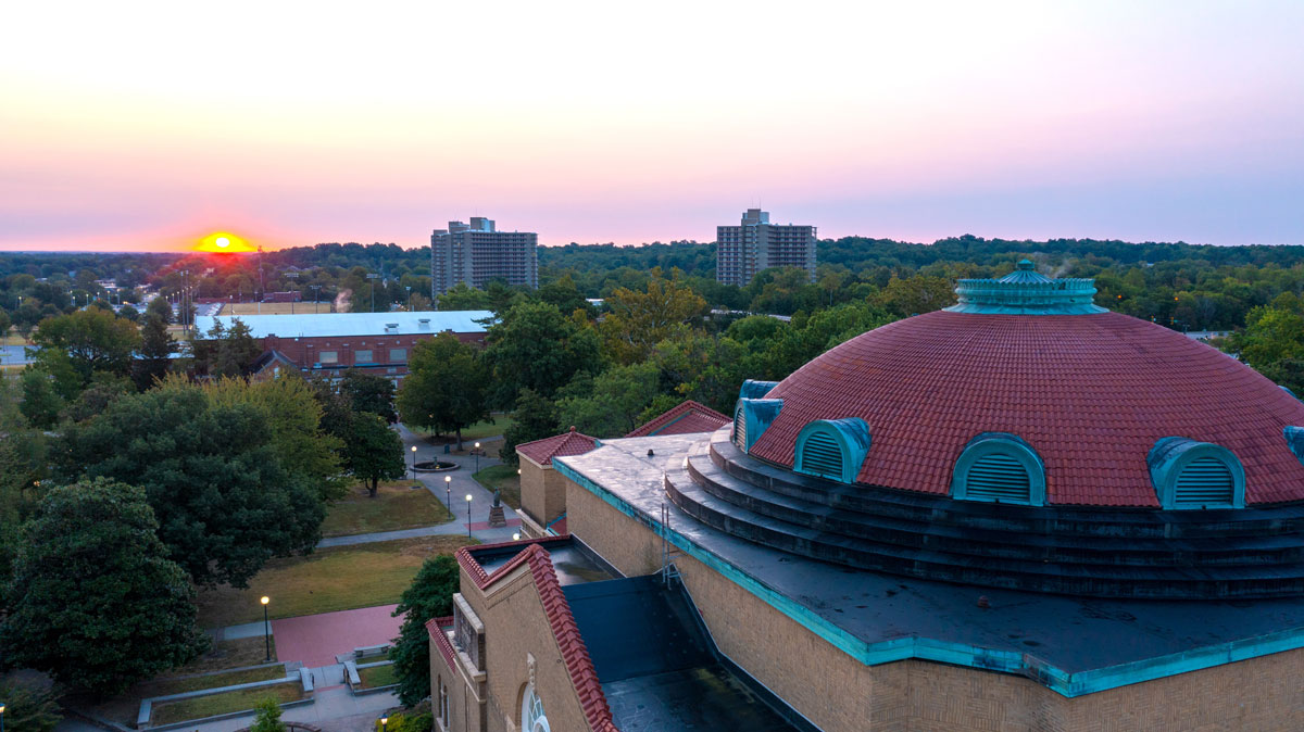 The sun rises over campus.
