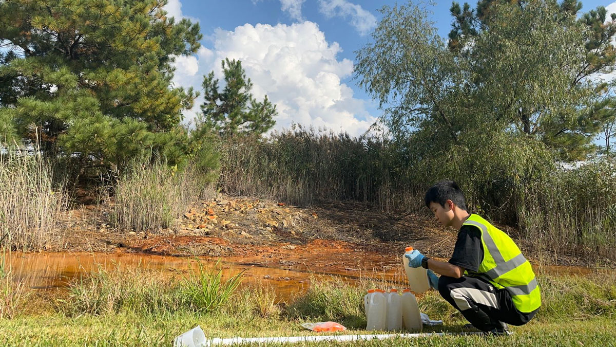 A grad student collects samples from an abandoned coal mine.