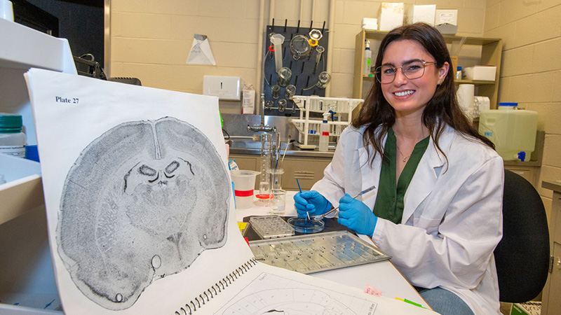 Ella Kerr examines rat brain specimens