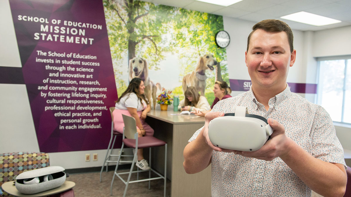Scott Boatright holds up virtual training device