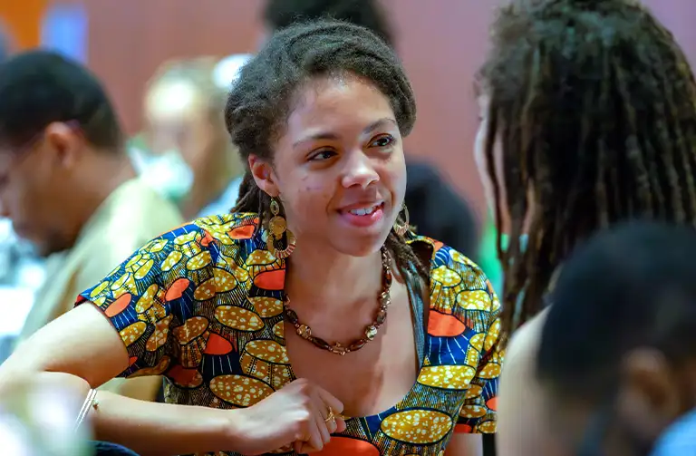 Student engaged in a lively conversation during a cultural event at Southern Illinois University.