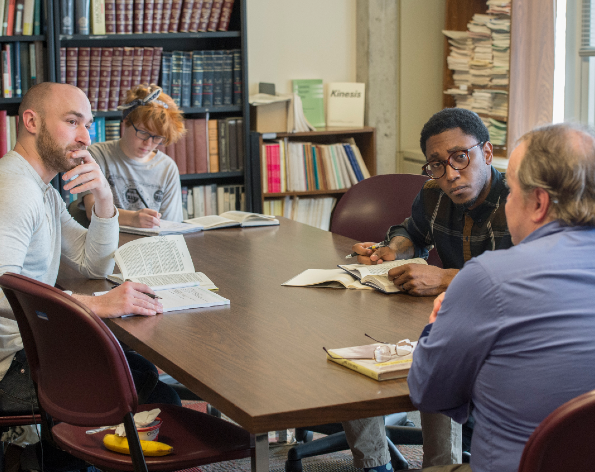 SIU Philosophy Students in discussion around a table.